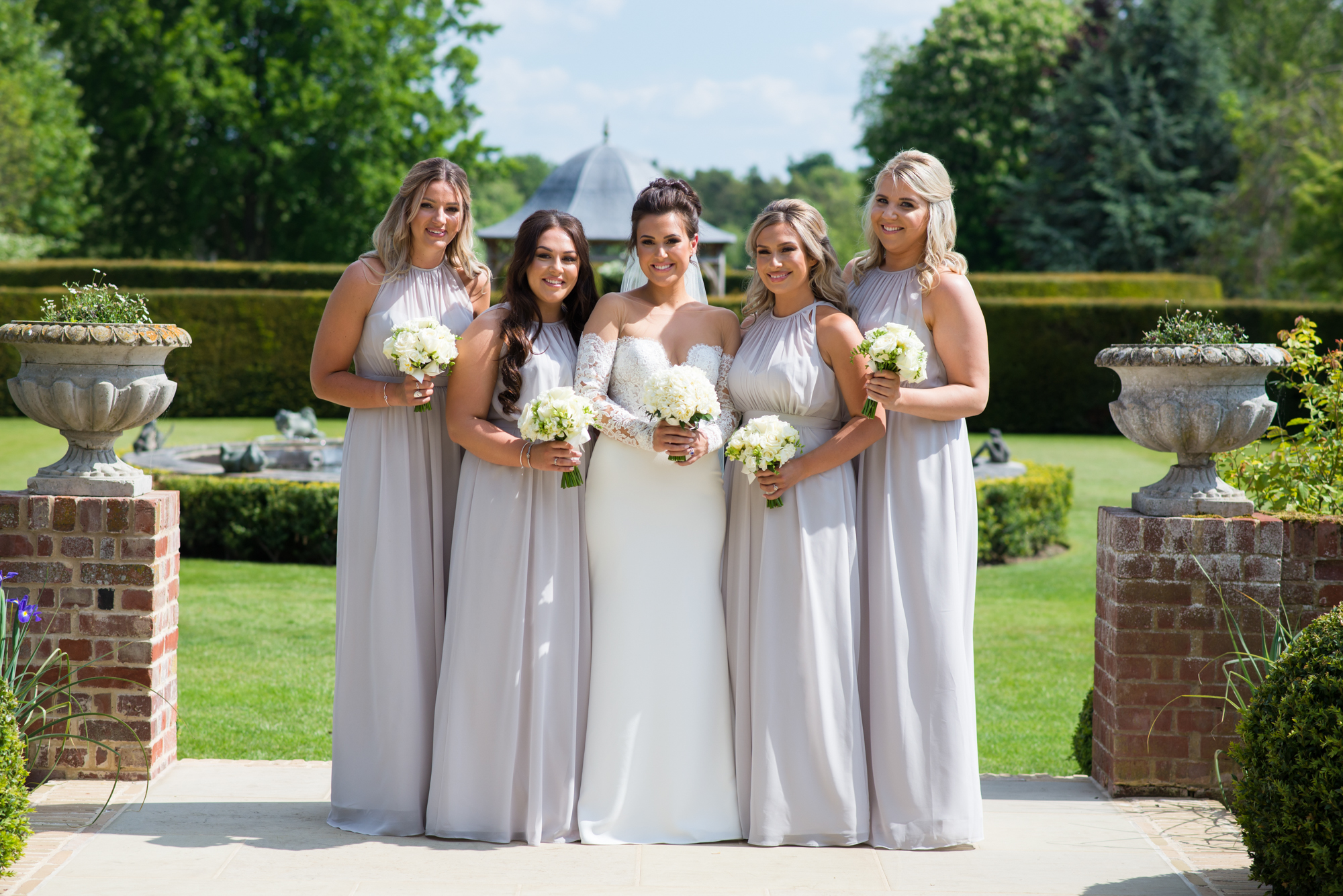 Bride wearing a pronovias bridal gown and bridesmaids wearing mia sposa dresses
